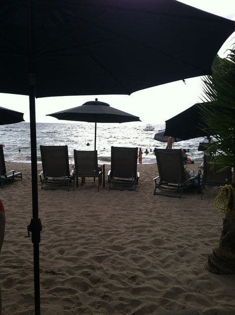 A picture of chairs and umbrella on the beach