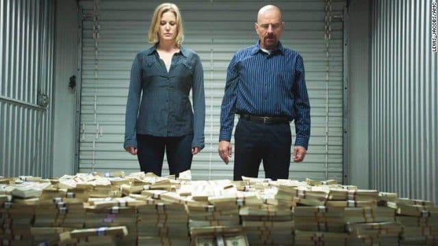 A picture of Skyler and Walter White looking at money